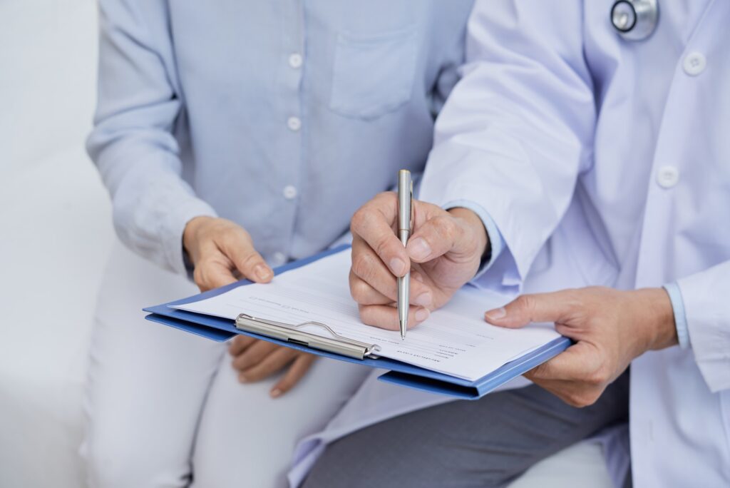 Doctor checking patient's medical record.