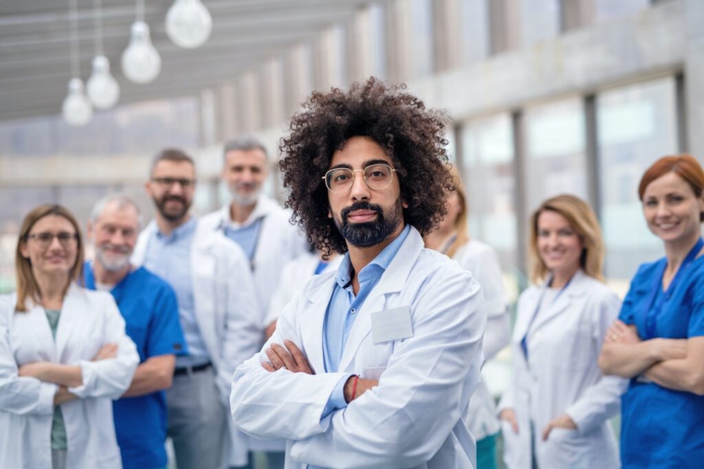 Group of doctors and nurses smiling in a clinic setting