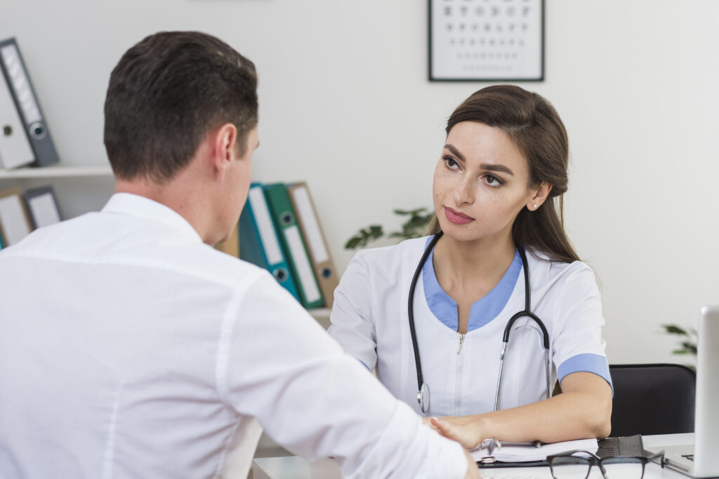 A female doctor is checking a male doctor
