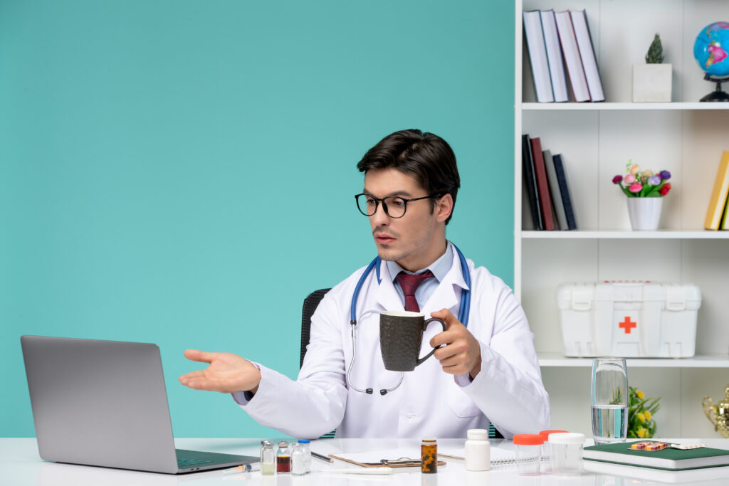 Young doctor handling patients online through laptop